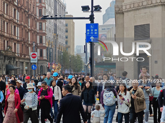 Chinese and foreign tourists bustle along the Nanjing Road Pedestrian Street in Shanghai, China, on October 28, 2024. (