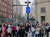 Chinese and foreign tourists bustle along the Nanjing Road Pedestrian Street in Shanghai, China, on October 28, 2024. (