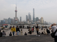 Tourists tour on a waterfront landscape platform along the Bund in Shanghai, China, on October 28, 2024. (