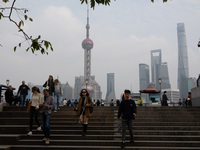 Tourists tour on a waterfront landscape platform along the Bund in Shanghai, China, on October 28, 2024. (