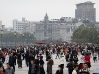 Tourists tour on a waterfront landscape platform along the Bund in Shanghai, China, on October 28, 2024. (