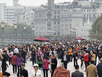 Tourists tour on a waterfront landscape platform along the Bund in Shanghai, China, on October 28, 2024. (