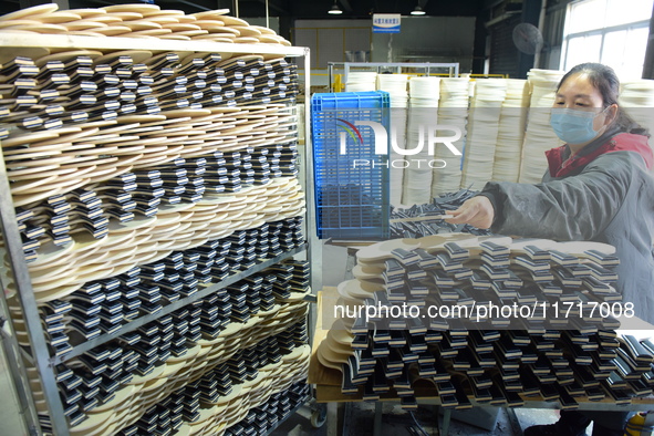 A worker produces table tennis bats for export in Lianyungang, China, on October 28, 2024. 