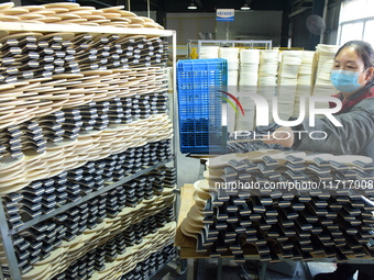 A worker produces table tennis bats for export in Lianyungang, China, on October 28, 2024. (