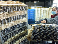 A worker produces table tennis bats for export in Lianyungang, China, on October 28, 2024. (