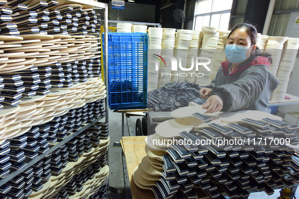 A worker produces table tennis bats for export in Lianyungang, China, on October 28, 2024. 