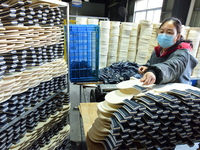 A worker produces table tennis bats for export in Lianyungang, China, on October 28, 2024. (