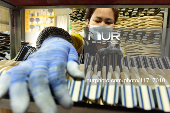 A worker produces table tennis bats for export in Lianyungang, China, on October 28, 2024. 