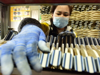 A worker produces table tennis bats for export in Lianyungang, China, on October 28, 2024. (