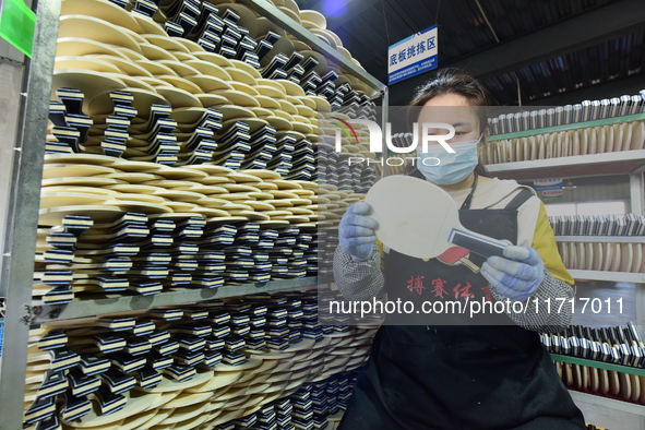 A worker produces table tennis bats for export in Lianyungang, China, on October 28, 2024. 