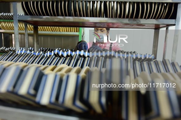 A worker produces table tennis bats for export in Lianyungang, China, on October 28, 2024. 