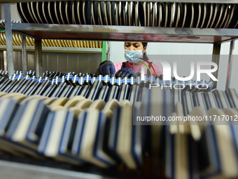 A worker produces table tennis bats for export in Lianyungang, China, on October 28, 2024. (