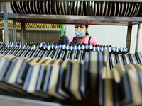 A worker produces table tennis bats for export in Lianyungang, China, on October 28, 2024. (