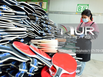 A worker produces table tennis bats for export in Lianyungang, China, on October 28, 2024. (