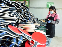 A worker produces table tennis bats for export in Lianyungang, China, on October 28, 2024. (