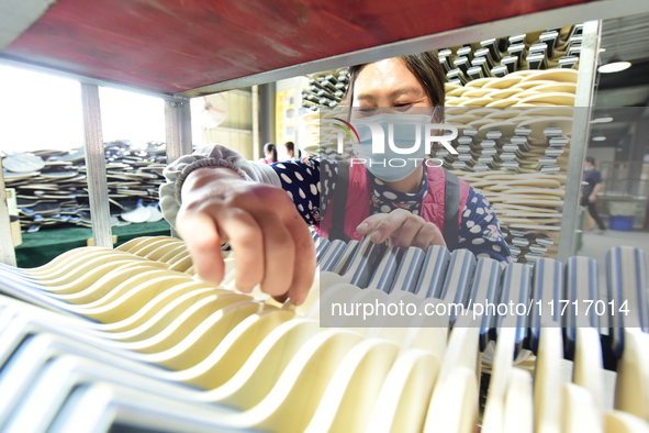 A worker produces table tennis bats for export in Lianyungang, China, on October 28, 2024. 