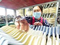 A worker produces table tennis bats for export in Lianyungang, China, on October 28, 2024. (