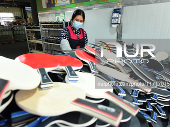 A worker produces table tennis bats for export in Lianyungang, China, on October 28, 2024. (