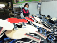 A worker produces table tennis bats for export in Lianyungang, China, on October 28, 2024. (