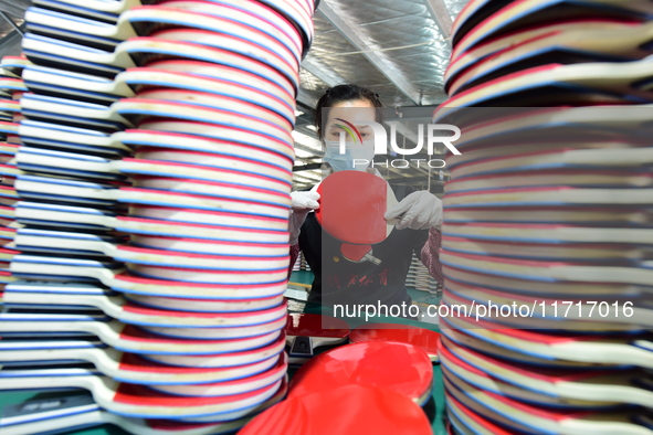 A worker produces table tennis bats for export in Lianyungang, China, on October 28, 2024. 