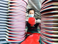 A worker produces table tennis bats for export in Lianyungang, China, on October 28, 2024. (