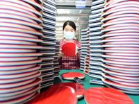 A worker produces table tennis bats for export in Lianyungang, China, on October 28, 2024. (