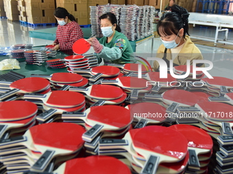 A worker produces table tennis bats for export in Lianyungang, China, on October 28, 2024. (