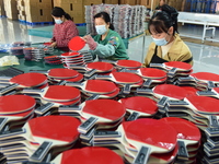 A worker produces table tennis bats for export in Lianyungang, China, on October 28, 2024. (