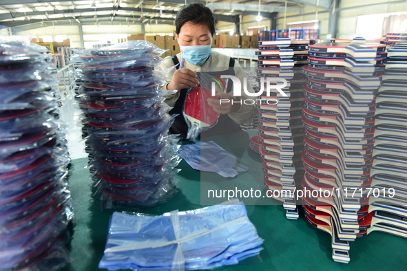 A worker produces table tennis bats for export in Lianyungang, China, on October 28, 2024. 