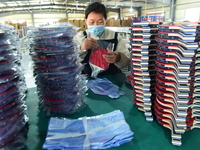 A worker produces table tennis bats for export in Lianyungang, China, on October 28, 2024. (