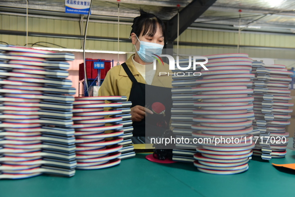 A worker produces table tennis bats for export in Lianyungang, China, on October 28, 2024. 