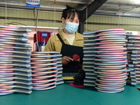 A worker produces table tennis bats for export in Lianyungang, China, on October 28, 2024. (