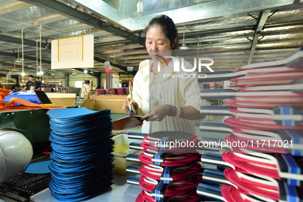 A worker produces table tennis bats for export in Lianyungang, China, on October 28, 2024. 