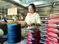 A worker produces table tennis bats for export in Lianyungang, China, on October 28, 2024. (