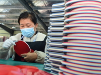 A worker produces table tennis bats for export in Lianyungang, China, on October 28, 2024. (