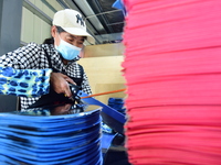 A worker produces table tennis bats for export in Lianyungang, China, on October 28, 2024. (