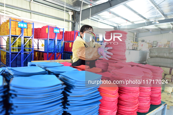 A worker produces table tennis bats for export in Lianyungang, China, on October 28, 2024. 