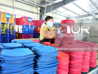 A worker produces table tennis bats for export in Lianyungang, China, on October 28, 2024. (