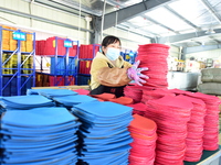 A worker produces table tennis bats for export in Lianyungang, China, on October 28, 2024. (