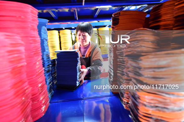 A worker produces table tennis bats for export in Lianyungang, China, on October 28, 2024. 