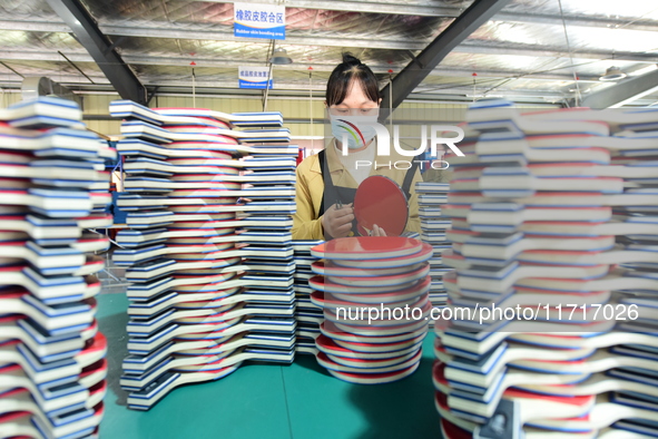 A worker produces table tennis bats for export in Lianyungang, China, on October 28, 2024. 