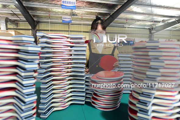 A worker produces table tennis bats for export in Lianyungang, China, on October 28, 2024. 