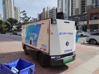 An unmanned delivery vehicle delivers packages for customers at a courier point in downtown Huai'an city, East China's Jiangsu province, on...