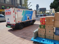 An unmanned delivery vehicle delivers packages for customers at a courier point in downtown Huai'an city, East China's Jiangsu province, on...