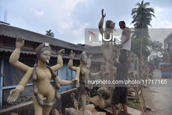 An artist works on an idol of the Hindu goddess Kali at a roadside workshop ahead of the Kali Puja festival in Nagaon District, Assam, India...