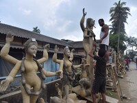 An artist works on an idol of the Hindu goddess Kali at a roadside workshop ahead of the Kali Puja festival in Nagaon District, Assam, India...