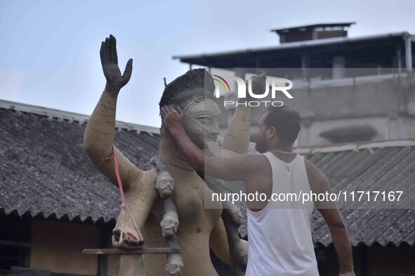 An artist works on an idol of the Hindu goddess Kali at a roadside workshop ahead of the Kali Puja festival in Nagaon District, Assam, India...