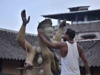 An artist works on an idol of the Hindu goddess Kali at a roadside workshop ahead of the Kali Puja festival in Nagaon District, Assam, India...