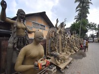 An artist works on an idol of the Hindu goddess Kali at a roadside workshop ahead of the Kali Puja festival in Nagaon District, Assam, India...