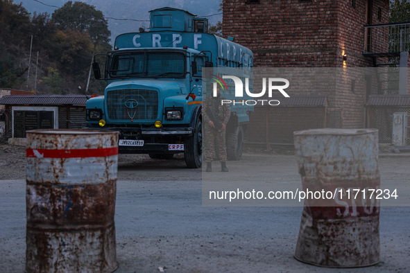 Indian soldiers stand alert while frisking vehicles and suspected persons in Baramulla, Jammu and Kashmir, India, on October 28, 2024. In th...